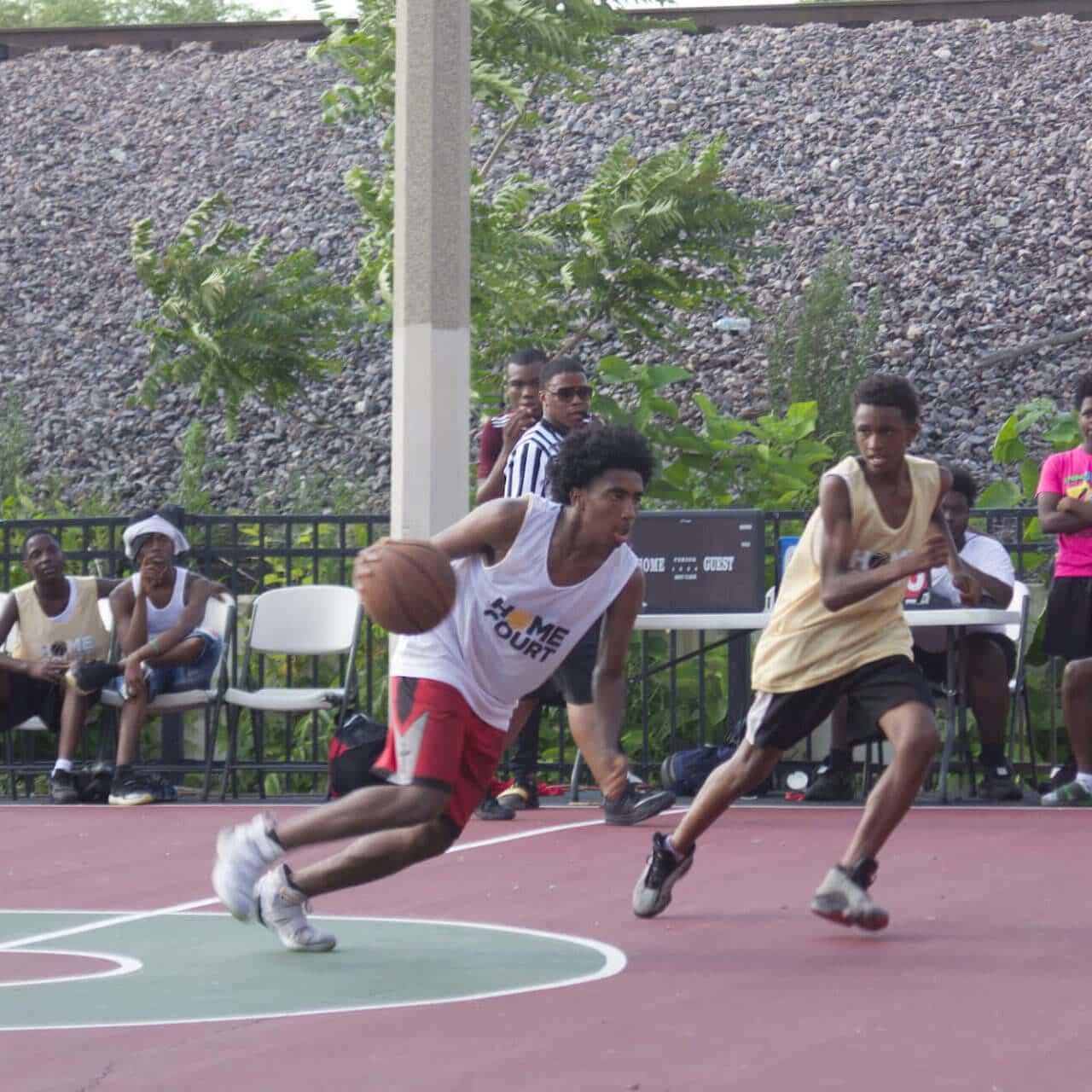 youth playing basketball at outdoor court