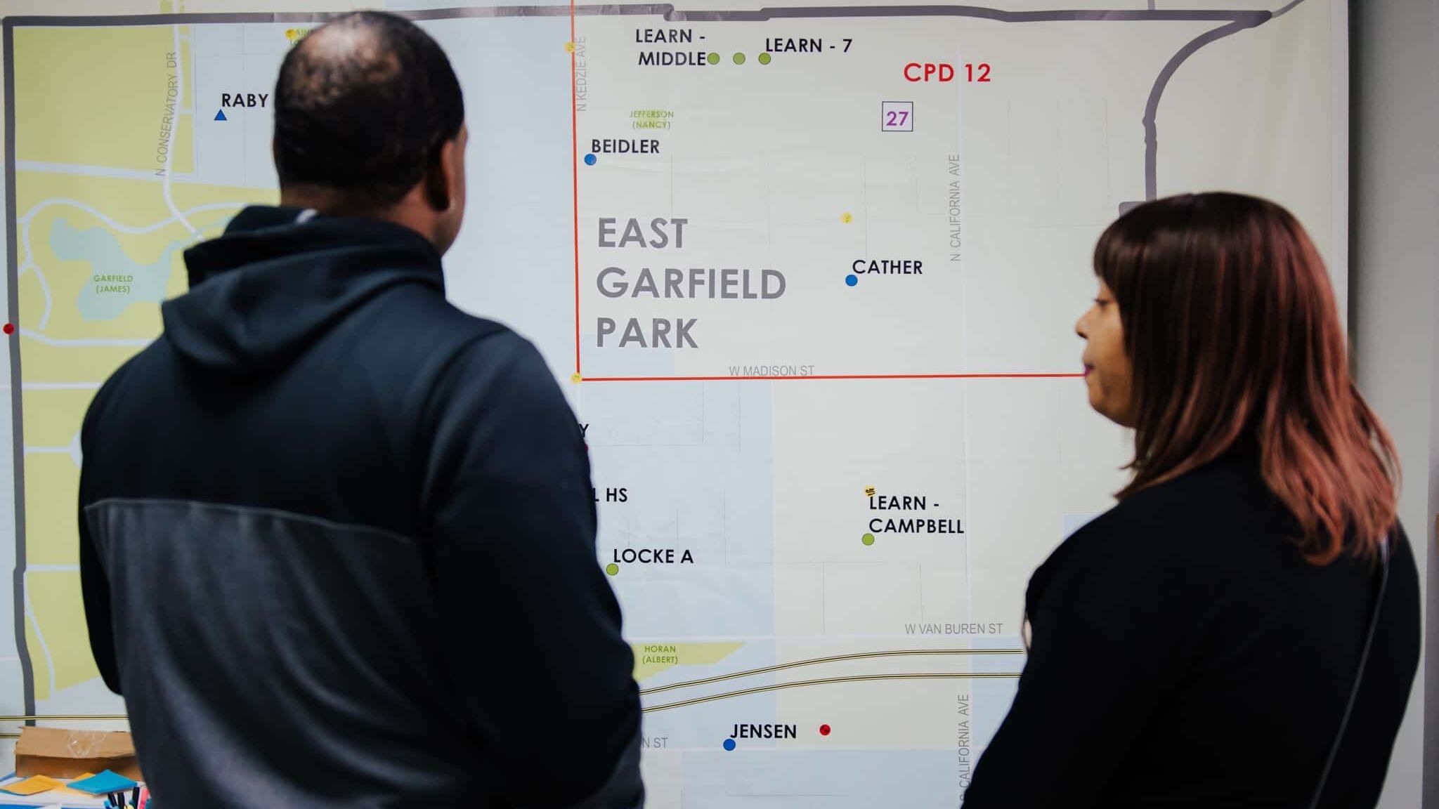 Breakthrough Violence Prevention staff looking at map of East Garfield Park