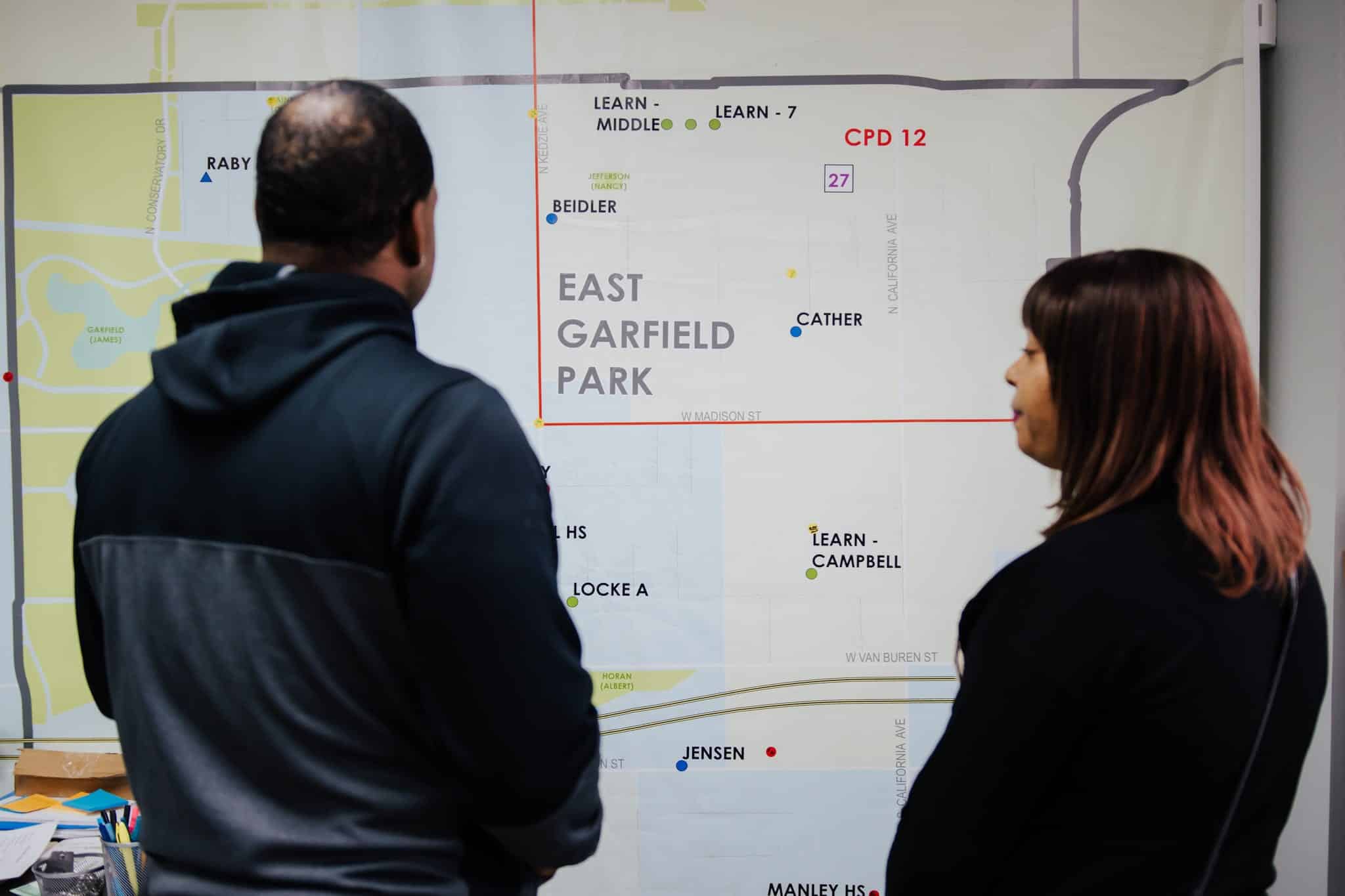 Breakthrough Violence Prevention staff looking at map of East Garfield Park